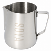 A stainless steel milk pitcher with a brushed finish, featuring a rectangular handle and the brand name 'SOYA' debossed vertically on the front, set against a plain white background.