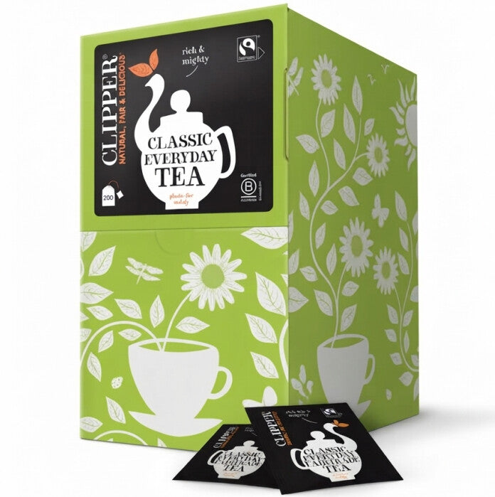 A green and white patterned tea box labeled Clipper Classic Everyday Tea, with two individual tea sachets placed in front on a white background.