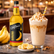 DaVinci banana syrup bottle with a banana milkshake and ingredients on a table.