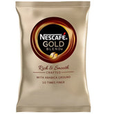 A single packet of Nescafe Gold Blend coffee capsules on a plain white background. The packaging is metallic gold with a large circular logo in the center and text below reading 'Rich & Smooth' and 'Crafted with Arabica Ground 10 Times Finer'.