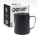 A black metal milk pitcher with a handle and pouring spout, shown in front of its white and black Rhino Classic Milk Pitcher box on a light gray background.