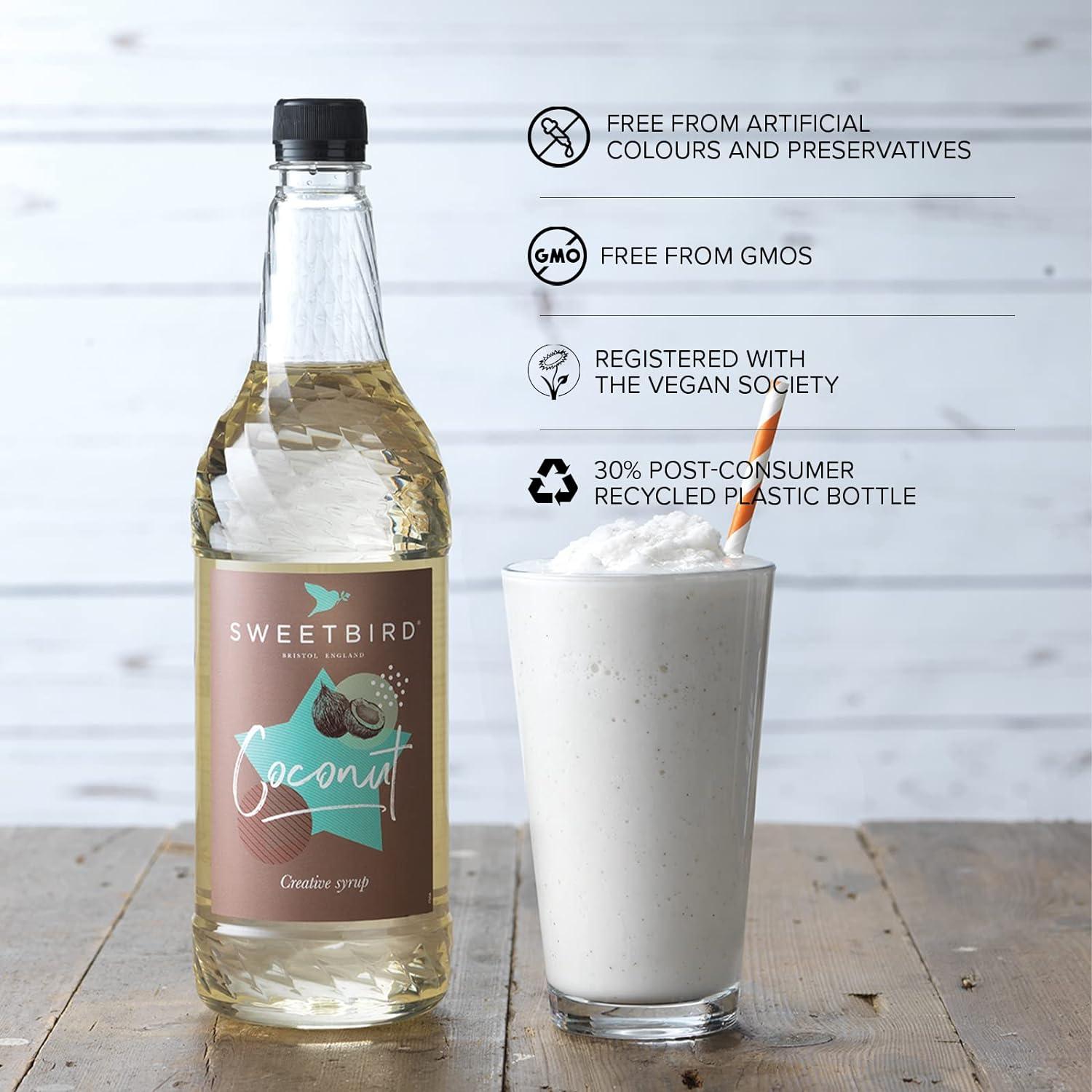 Sweetbird coconut syrup bottle with a glass of whipped cream and a straw on a wooden surface.