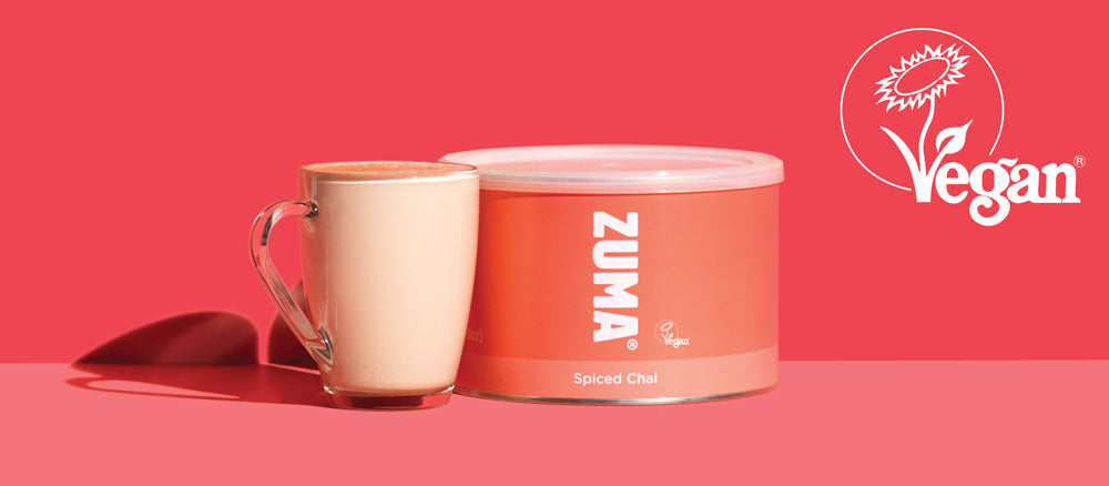 Zuma Spiced Chai container with a mug on a red background, featuring the Vegan logo.